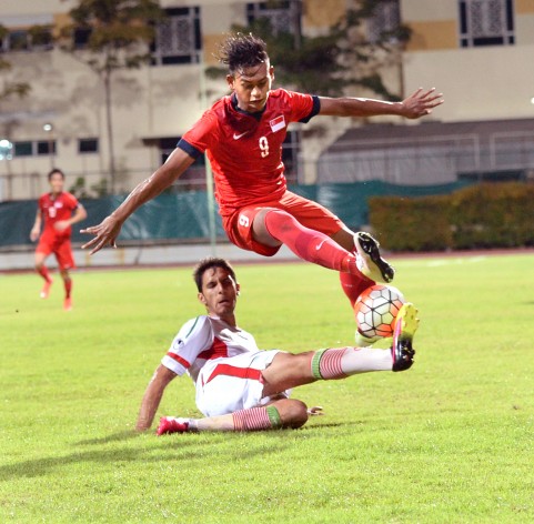 Singapore Under-21 striker Amiruldin Asraf vaulting over an Iranian opponent during the 1-0 defeat at the hands of the visitors in the Under-21 International Challenge final at Bishan Stadium yesterday. PHOTO: THE NEW PAPER